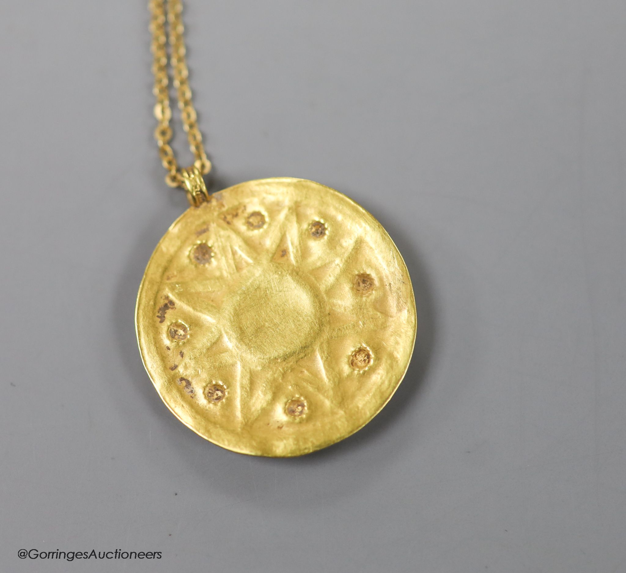 A modern Italian 18ct chain with a circular yellow metal possibly Roman pendant, 30mm, gross weight 7.8 grams